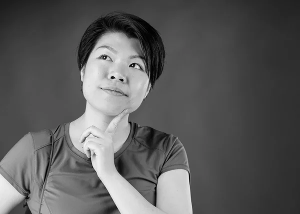 Woman thinking with finger on chin