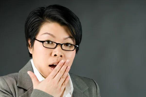 Shocked woman covering her mouth by hand