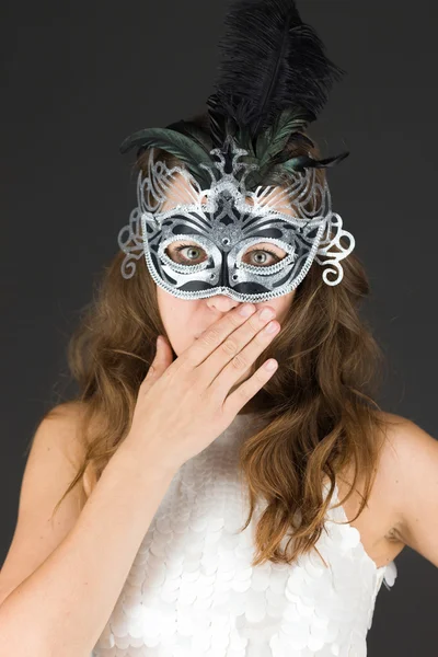 Model in carnaval mask hiding her face