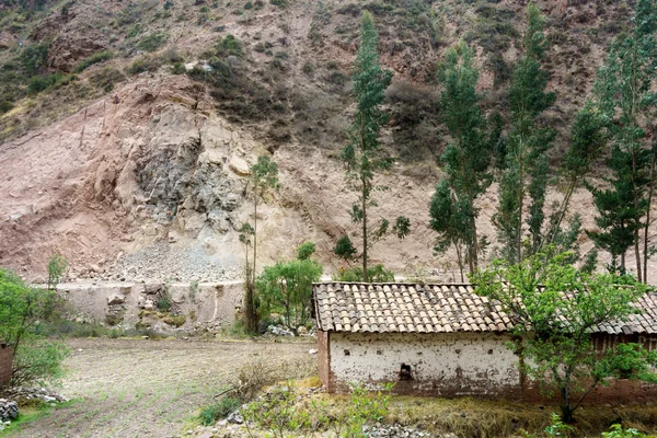 House on hill with mountain in background