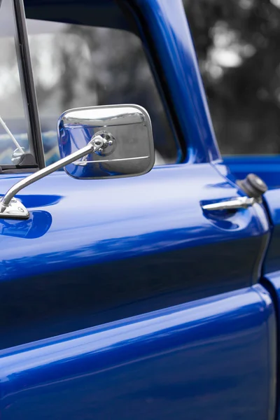 Wing mirror of a blue vintage car