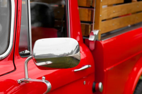 Wing mirror of a red vintage car