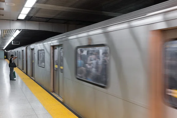 Subway platform with train passing through