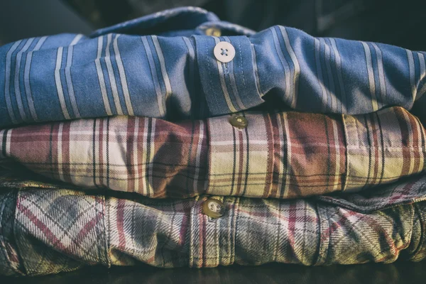 Row of colorful man shirts