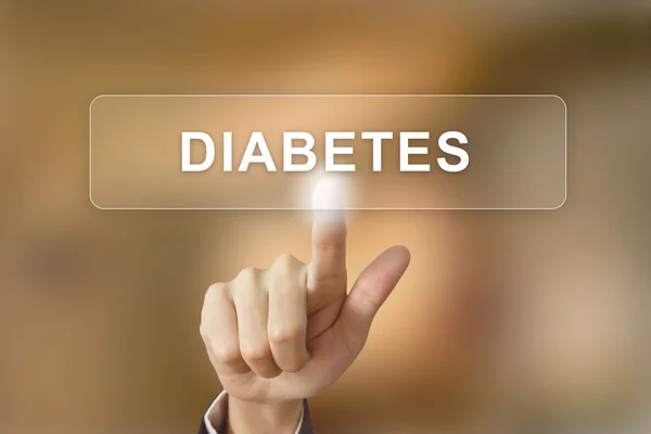 Hand clicking diabetes button on blurred background