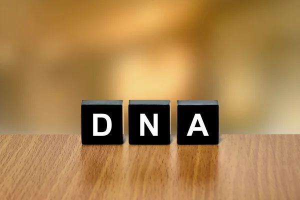 DNA or Deoxyribonucleic Acid on black block