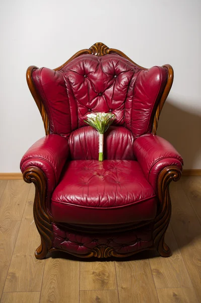 Wedding bouquet on a red armchair