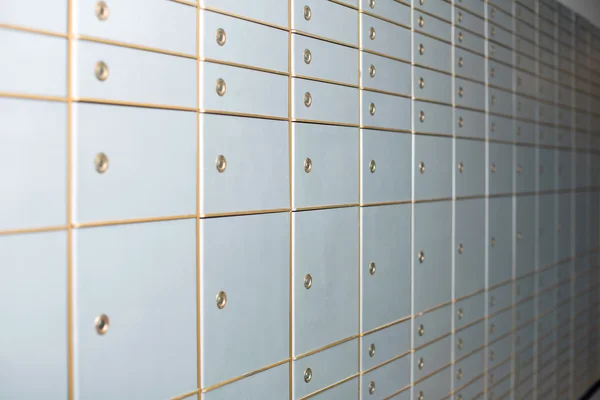 White closed lockers of various sizes on wall