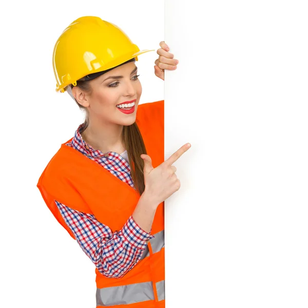 Smiling Woman Construction Worker Pointing
