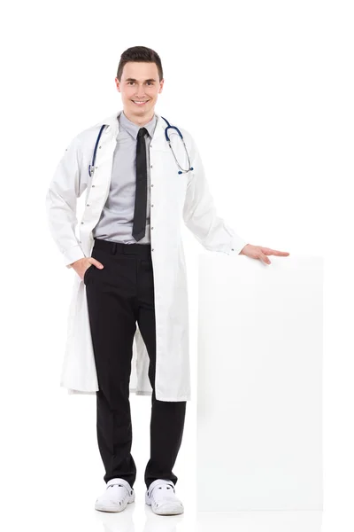 Happy male doctor posing with empty poster