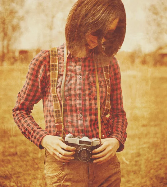 Woman holding vintage photo camera