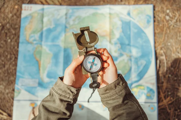 Traveler searching direction with compass