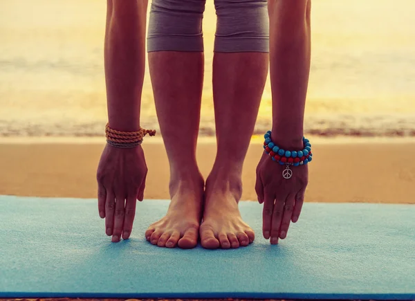 Girl doing yoga exercise on beach