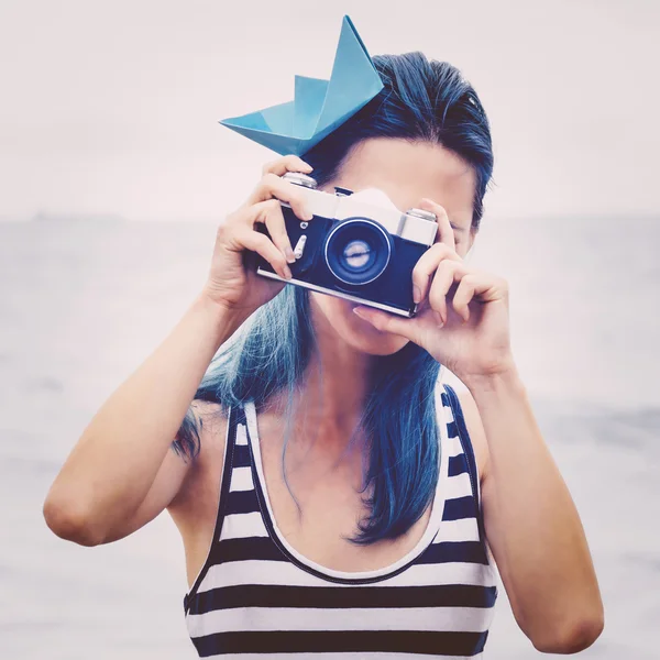 Girl takes a photograph on beach