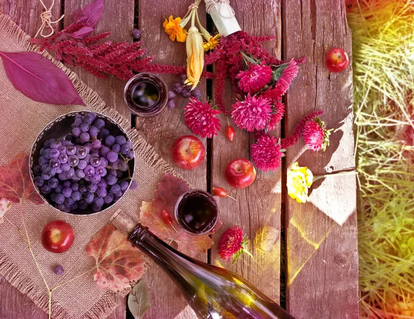 Apples, asters, autumn leaves and a bottle of wine