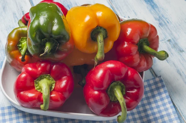 Green red and yellow peppers