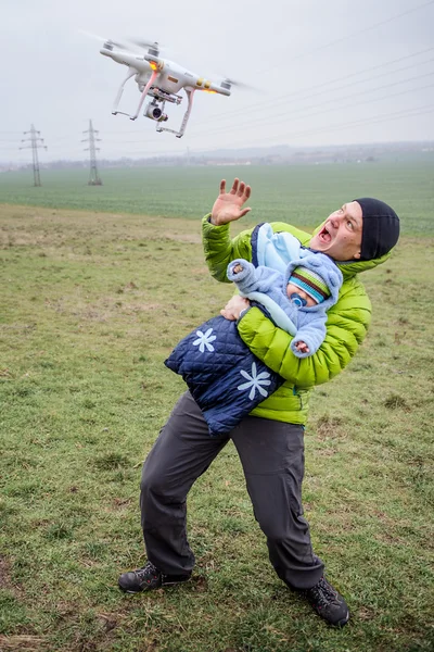 Man protects his baby against an attacking drone