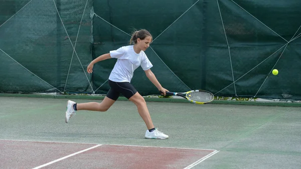 Girl with racket on tennis court