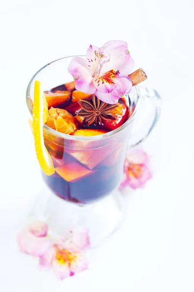 Flowers and mulled wine in glass