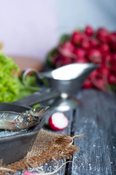 Fresh sardines. Fish with vegetables.