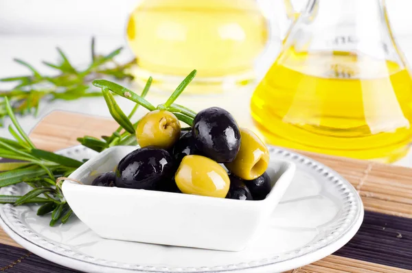 Olive oil and olive branch on the table