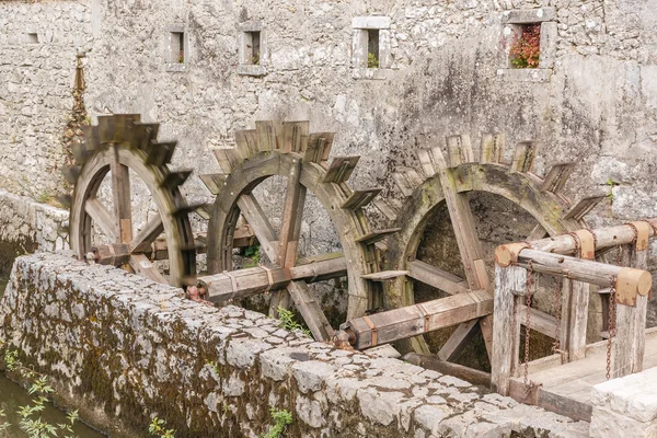 Detail of old water mill wheels and river