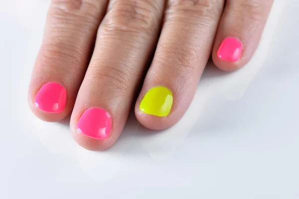Rainbow pastel manicure. New Hybrid nails on white background