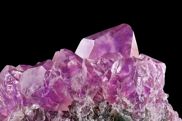 Crystal Stone macro mineral, purple rough amethyst quartz crystals on black background