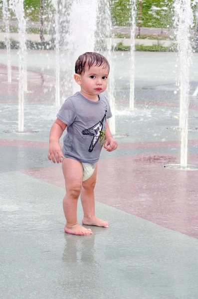 Unsure toddler in splash pad