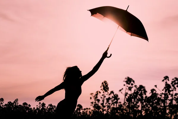 Unplugged free silhouette woman with umbrella fly to future