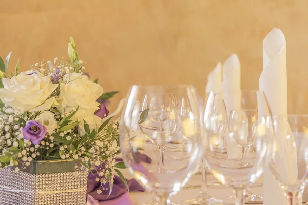 Premium dinner gala table with flowers napkins and glasses in ro