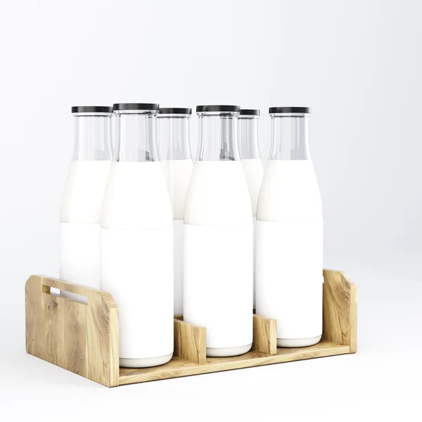 Six glass bottles of milk with black lids in wooden bottle box.