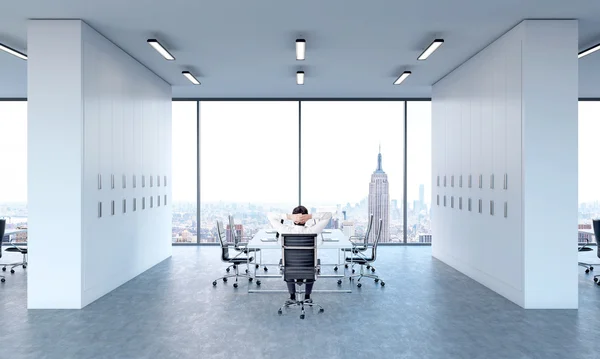 Man relaxing at meeting table