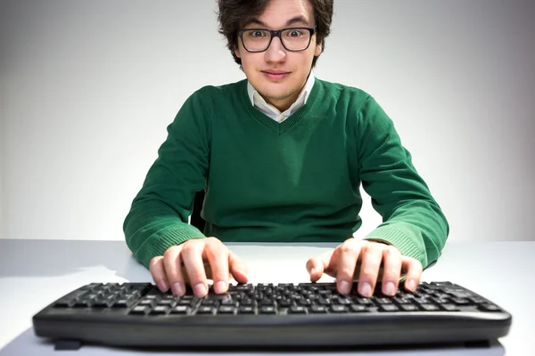 Surprised young man using keyboard