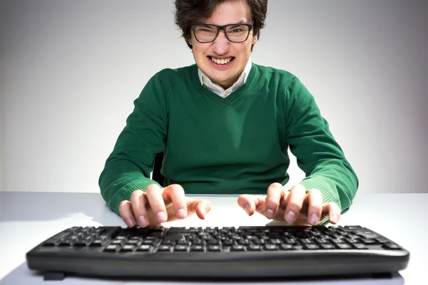 Grinning man using keyboard