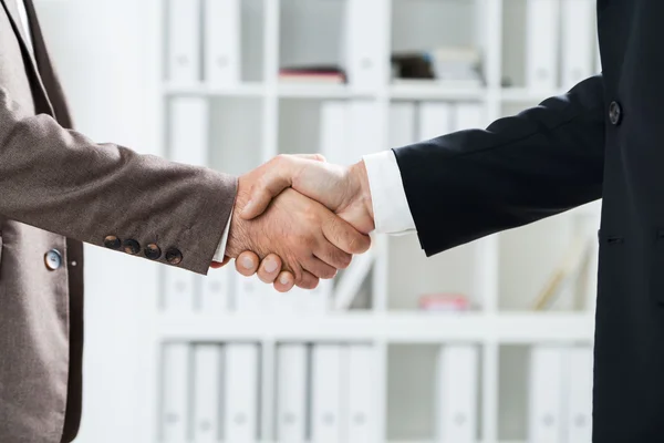 Businessmen handshake closeup