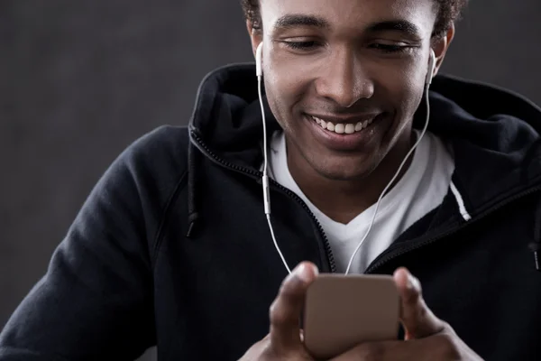 Smiling African American man listening to music