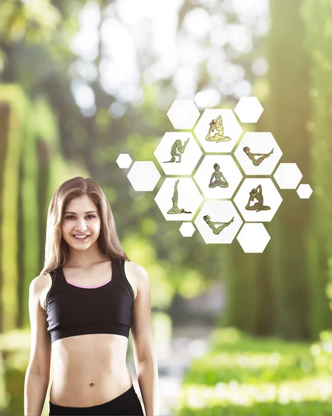 Smiling girl in park with yoga sketches