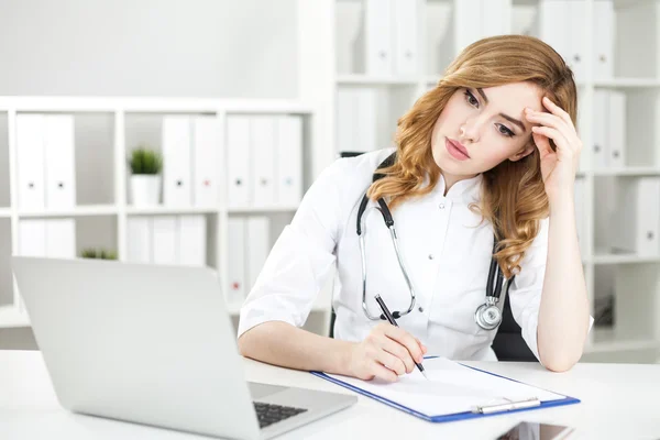 Stressed woman doctor thinking