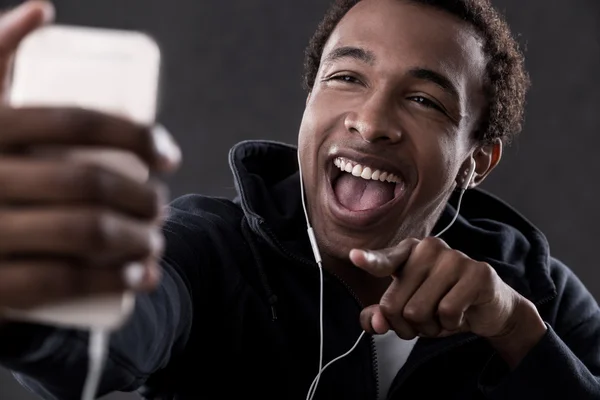 African American man pointing at phone screen