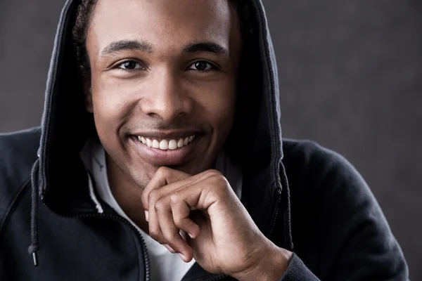 Close up of smiling African American man in hoodie