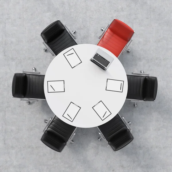 Top view of a conference room. A white round table, six chairs, one of them is red. A laptop and five papers. Office interior. 3D rendering.