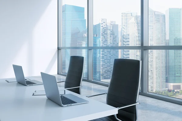 Modern meeting room with huge windows looking at Singapore business city. Black leather chairs and a white table with laptops. 3D rendering.