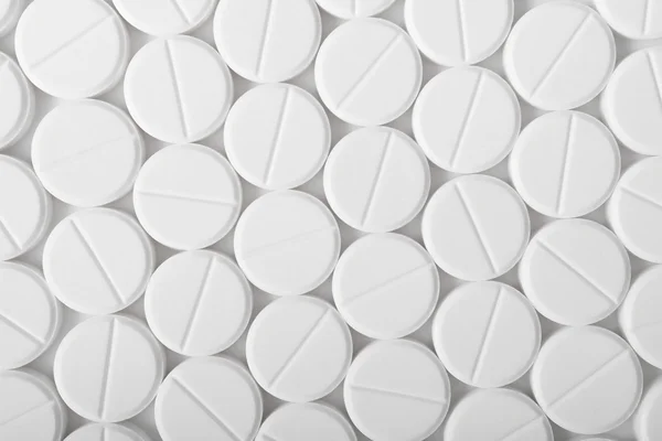 Heap of medicine pills. Background made from white pills.