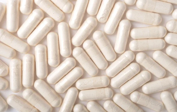 Medical background with white capsules