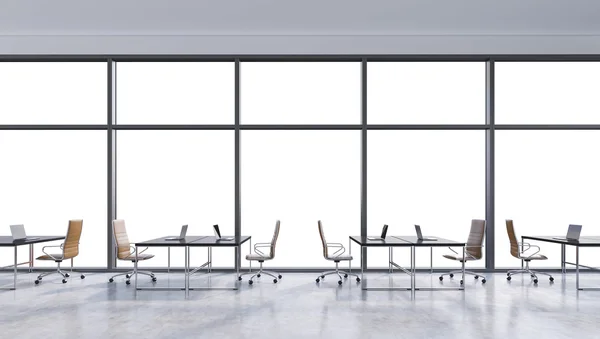 Workplaces in a modern panoramic office, copy space in the windows. Open space. Black tables and brown leather chairs. A concept of financial consulting services. 3D rendering.