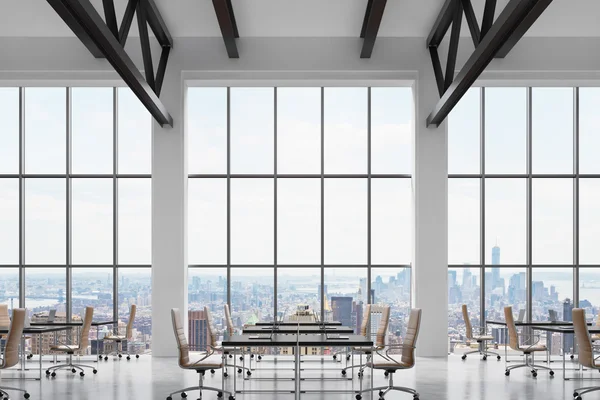 Modern workplaces in a modern bright clean interior of a loft style office. Huge windows with New York panoramic view. Black desks equipped with laptops, brown leather chairs. 3D rendering.