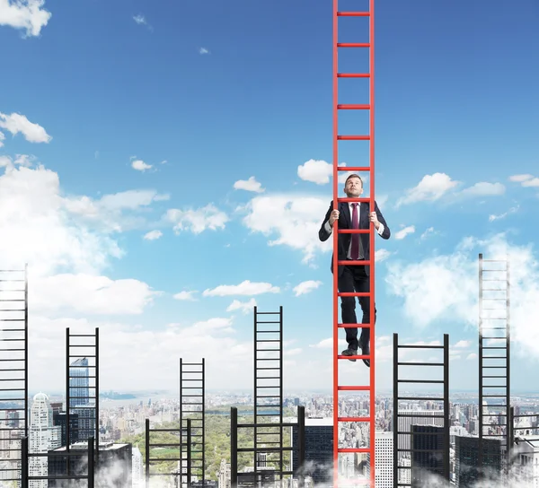 A concept of competition, and problem solving. A businessman choses the right ladder to achieve the success in career. New York city view.