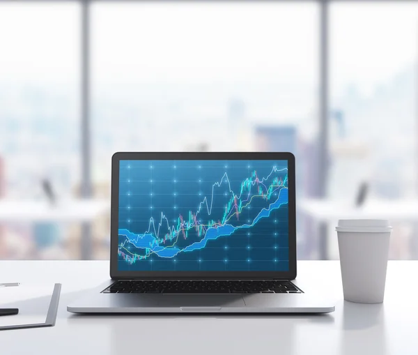 There are a laptop with forex chart on the screen, legal pad and a cup of coffee on the table. A modern workplace. 3D rendering. Modern office with panoramic New York view in blur on the background.