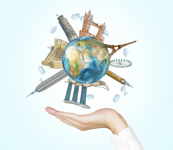 A hand holds a globe with sketched the most famous places in the world. A concept of tourism and sightseeing. Light blue background. Elements of this image furnished by NASA.